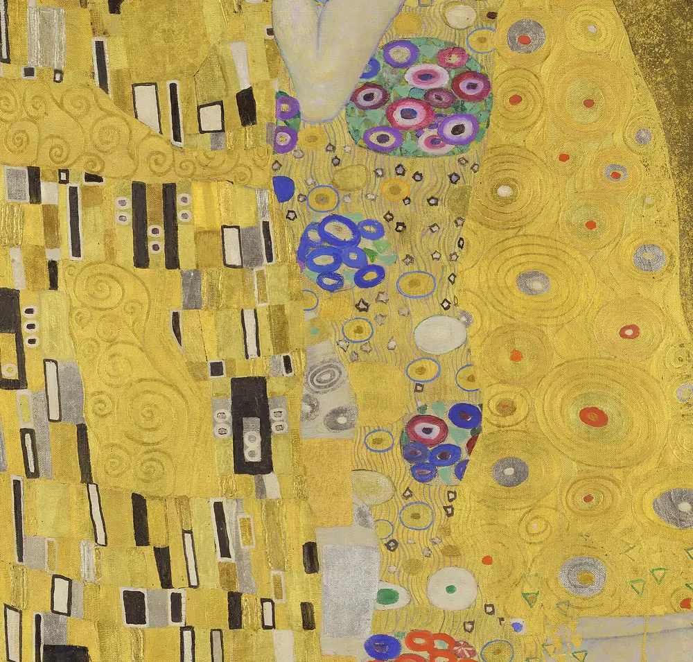 Detail of The Kiss showing the man's black, white and grey rectangles meeting the woman's coloured circles against a gold ground.