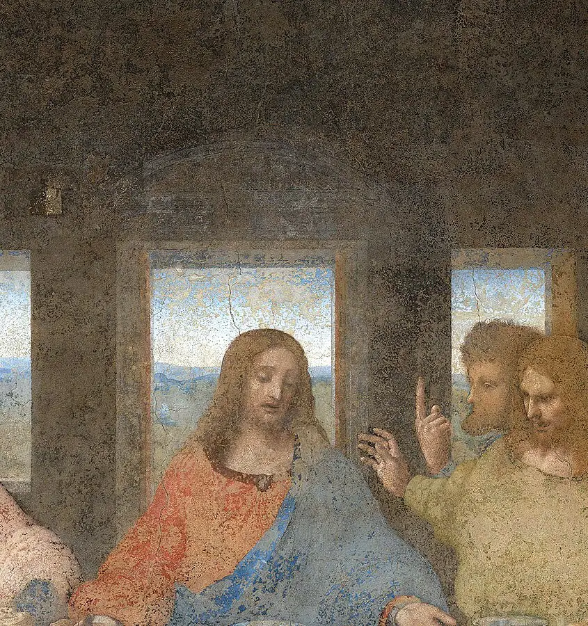 Detail of Christ's head against the central window, showing the mottled, faded surface and lost paint.